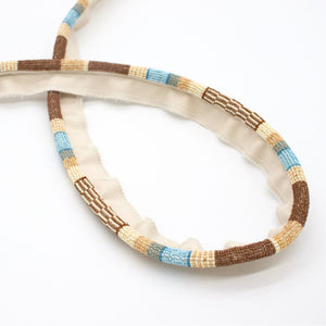 #hazelbrook Ferox beaded cord trim in Hazel Brook, looped to show the pattern repeat
