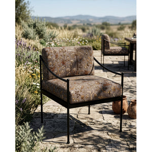 #autumn Mighty Jungle outdoor fabric in Autumn, upholstered on an outdoor armchair on a stone terrace