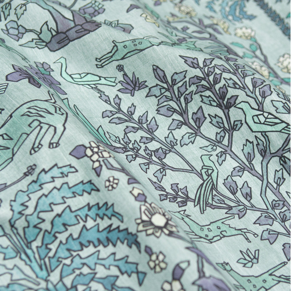 #lagune Mighty Jungle outdoor fabric in Lagune, draped to show the print in close detail