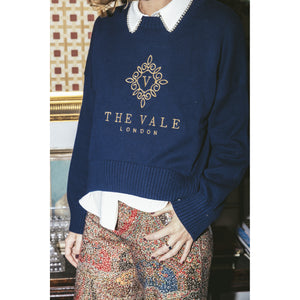 Close detail of the gold Vale London embroidery on the navy Embroidered Crewneck Sweater