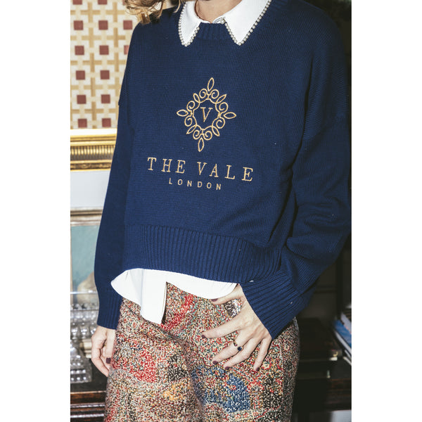 Close detail of the gold Vale London embroidery on the navy Embroidered Crewneck Sweater