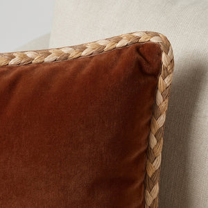 #all Detail of Fletta raffia braided cord trim applied to the edge of a rust velvet cushion