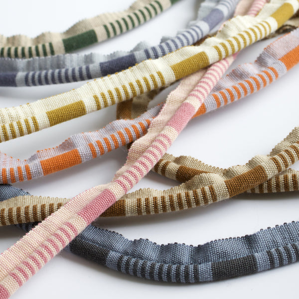 #all Linea ribbed wool cord trim in eight colourways, draped and overlapping