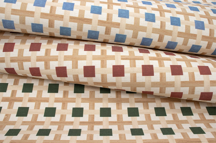Rolls of a Vale London lattice wallcovering in blue, red and green colourways